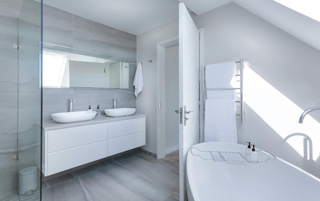 pexels-photo-1454804-1454804-1 Sleek contemporary bathroom with bathtub and twin sinks, showcasing minimalist design and luxury.